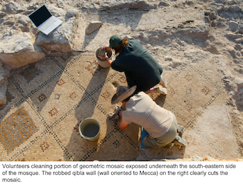 Volunteers cleaning portion of geometric mosaic exposed underneath the south-eastern side of the mosque.